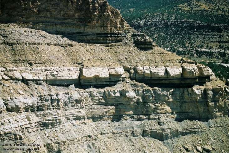 Coal seam split. The white sandstones in the cliff are marine shoreface parasequences.