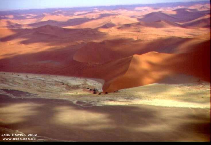 Modern fluvial aeolian interaction where a small empheral stream is diverted around the toe of a large linear dune. The Namib desert.